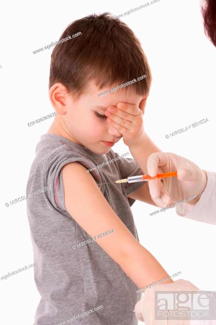 Photo de stock: Doctor giving a child injection in arm on isolated image.