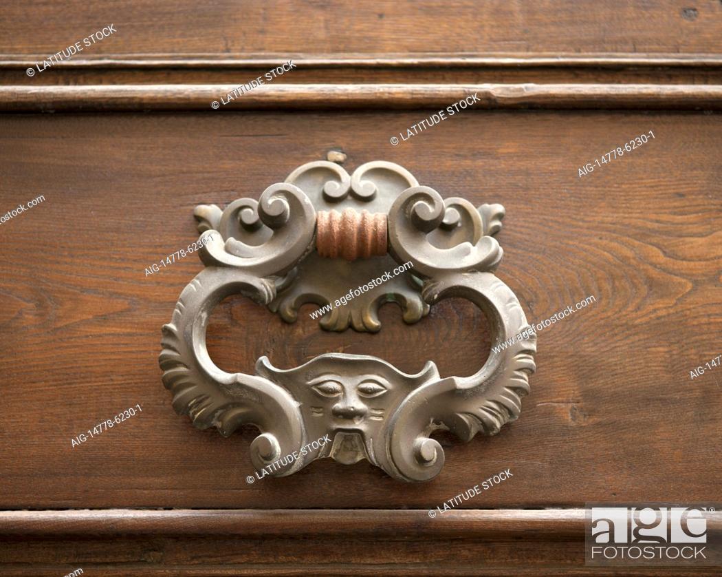 Stock Photo: The historic town of Lucca in Northern Tuscany is home to some fine examples of historic architecture including ornate door furniture.