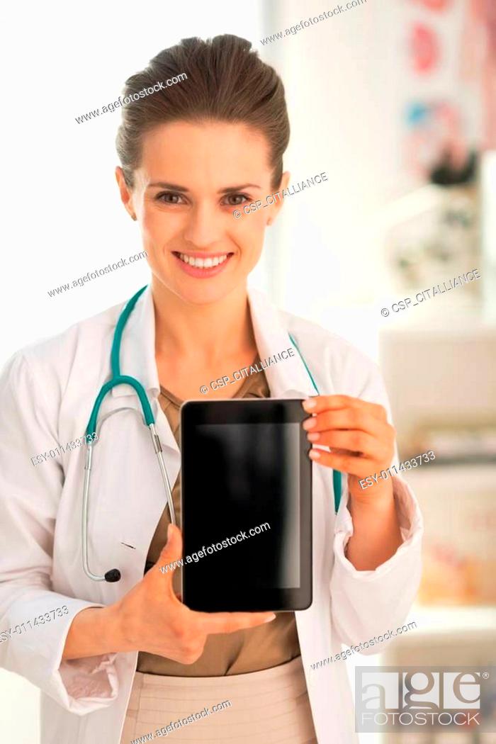 Stock Photo: Happy medical doctor woman showing tablet pc blank screen.
