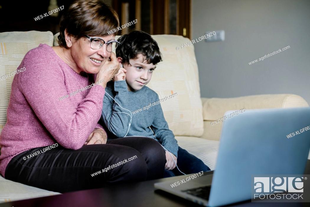 Stock Photo: Grandmother and grandson video chatting with laptop at home.