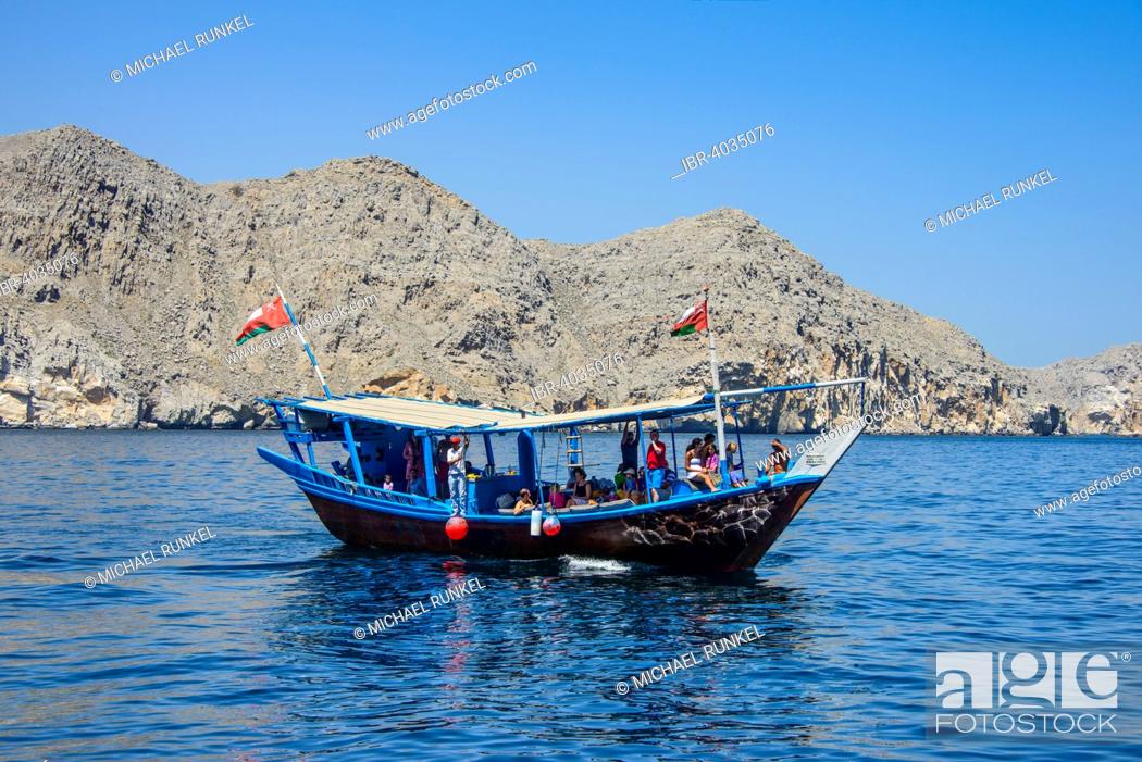 Stock Photo: Tourist boat in form of a dhow, Khor Ash Sham fjord, Musandam, Oman.