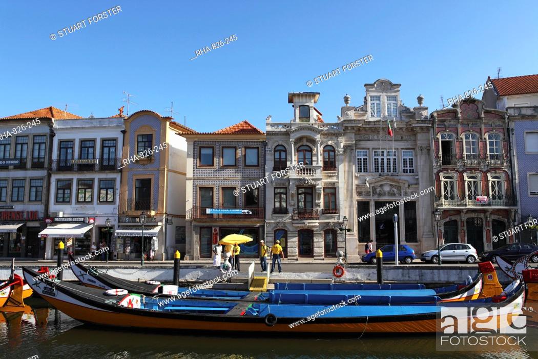 Stock Photo: Moliceiro boats docked by Art Nouveau style buildings along the Central Canal, Aveiro, Beira Litoral, Portugal, Europe.