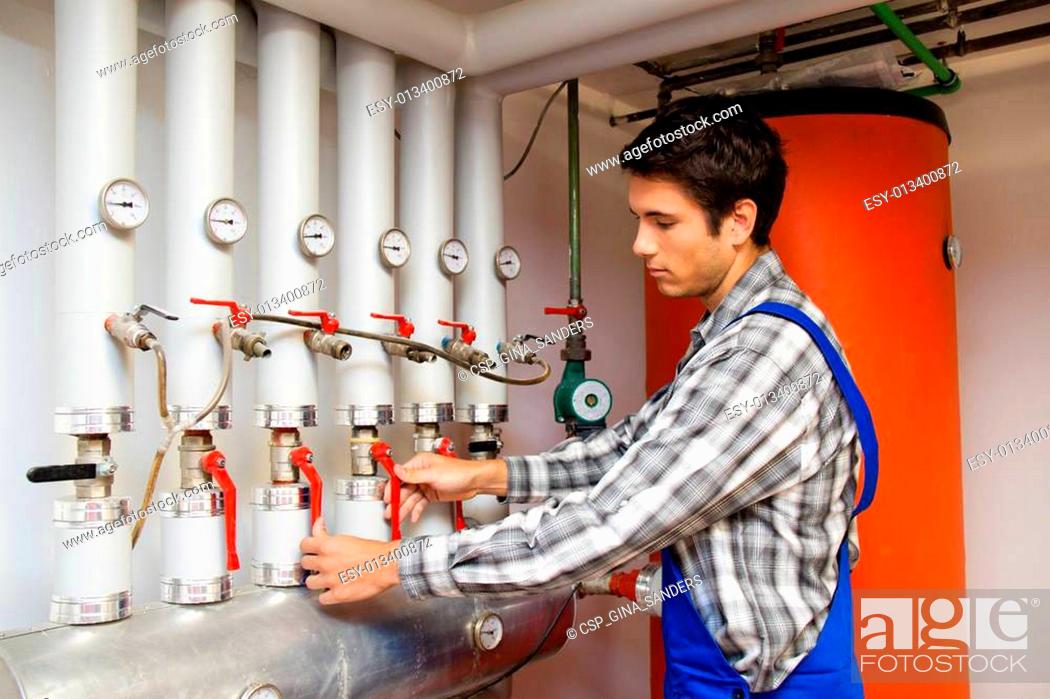Stock Photo: Heating engineer in a boiler room for heating system.