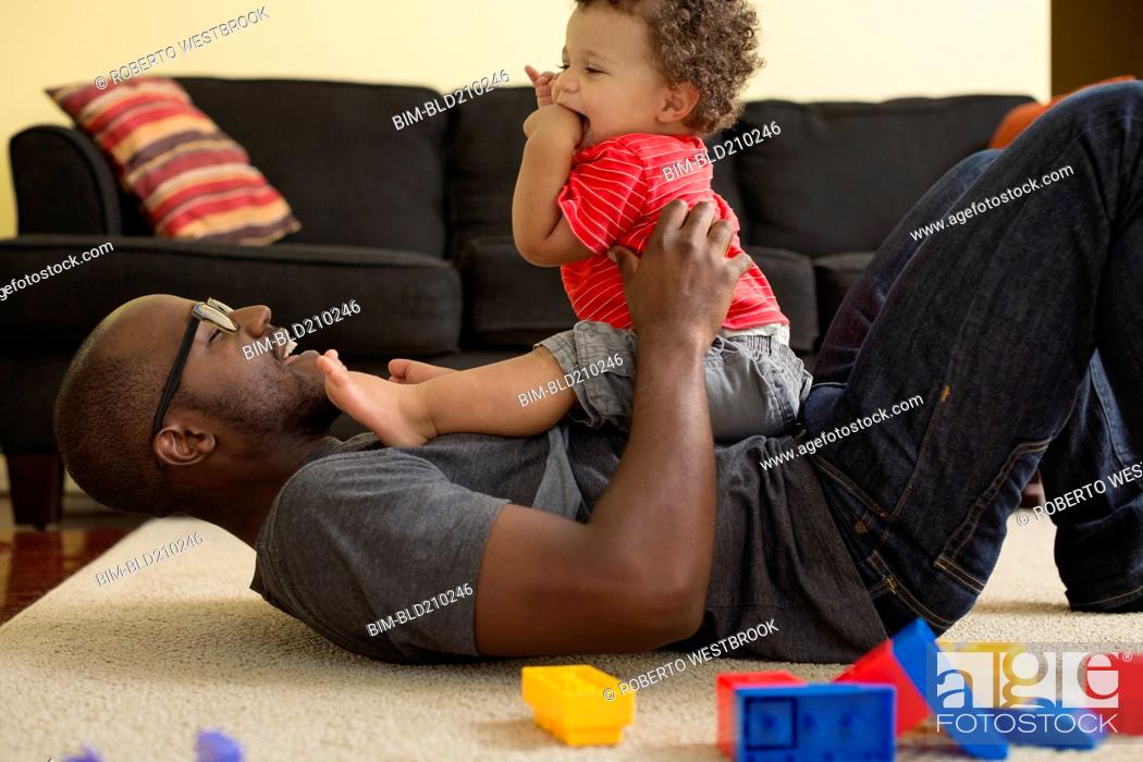 Stock Photo: Father and toddler son playing in living room.