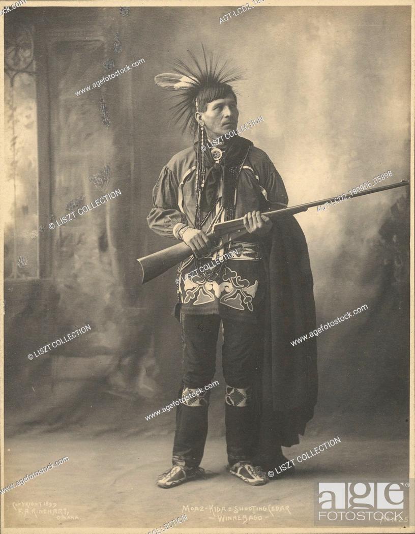 Stock Photo: Moaz-Kida= Shooting Cedar, Winnebago; Adolph F. Muhr (American, died 1913), Frank A. Rinehart (American, 1861 - 1928); 1899; Platinum print; 23.7 x 18.
