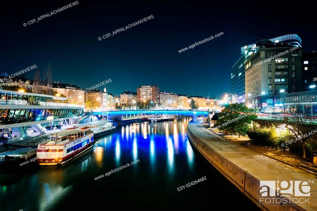 Stock Photo: Modern buildings and boats along the Danube Canal at night, in Vienna, Austria.