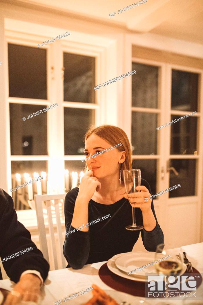 Stock Photo: Smiling woman sitting at table.
