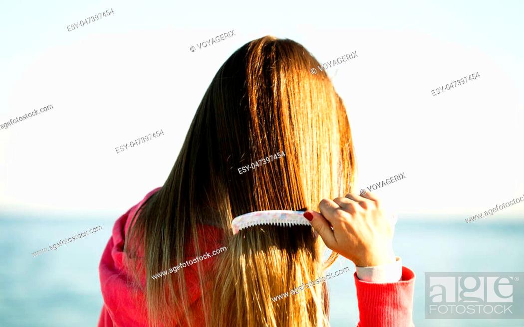 Woman refreshing her hairstyle after doing sports, girl relaxing and  combing hair with comb outdoor..., Stock Photo, Picture And Low Budget  Royalty Free Image. Pic. ESY-047397454 | agefotostock