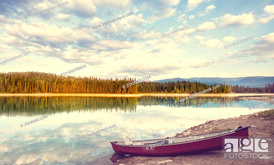 Stock Photo: Serene scene by the mountain lake in Canada with reflection of the rocks in the calm water.