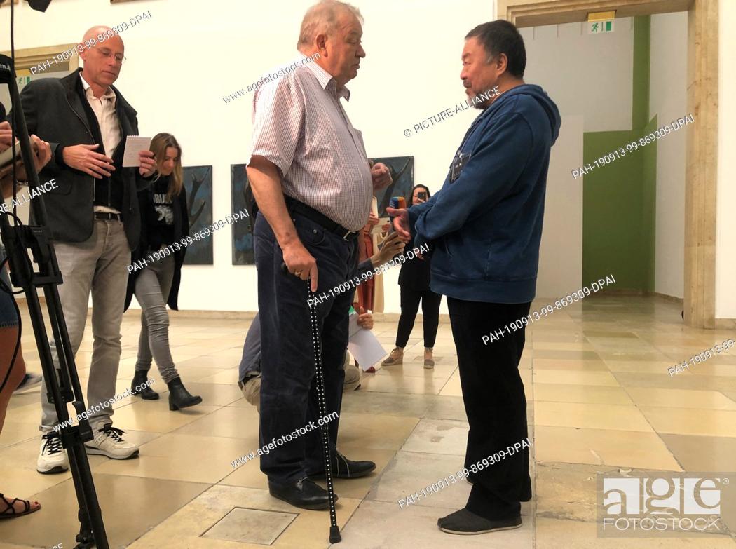Stock Photo: HANDOUT - 13 September 2019, Bavaria, Munich: Ai Weiwei (r), artist from China, talks at the Haus der Kunst with Bernhard Spies, managing director of the museum.