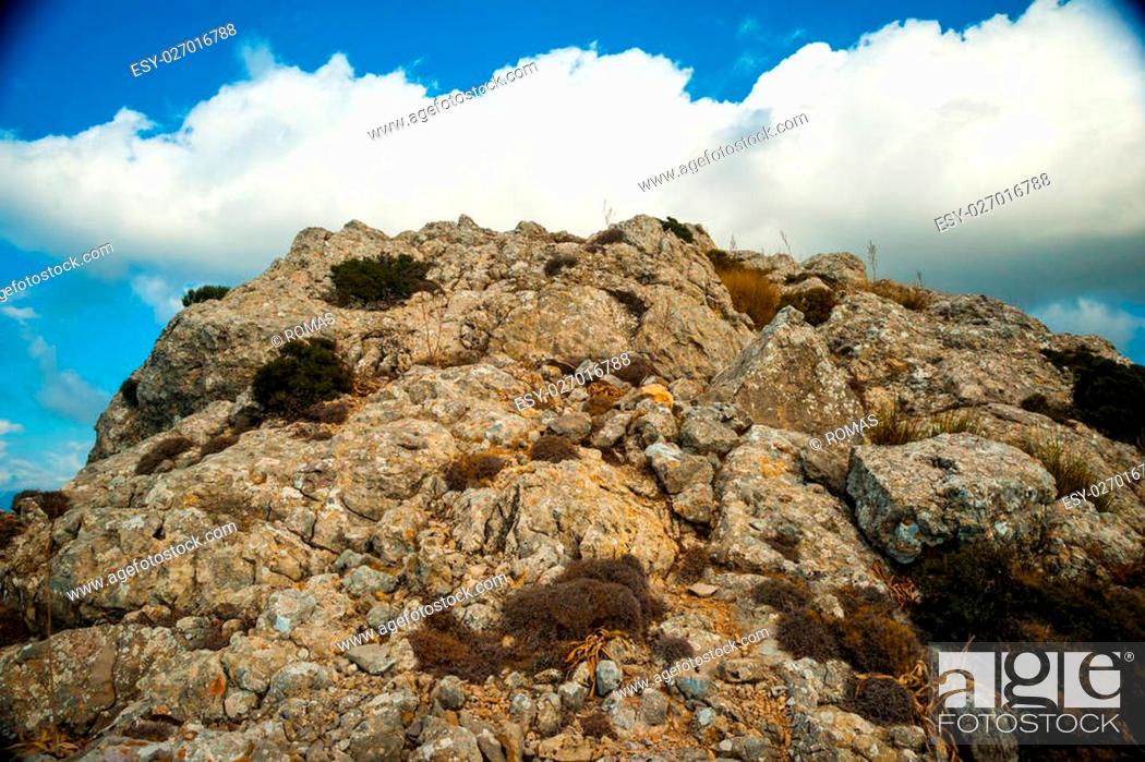 Stock Photo: Beautiful landscape with rocky mountains and clouds on the western part of Mallorca island, Spain. Tramuntana mountains with green bushes.