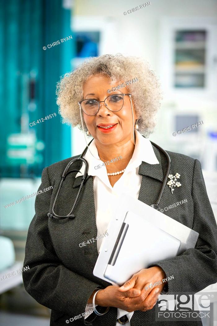 Stock Photo: Portrait confident female doctor making rounds in hospital.