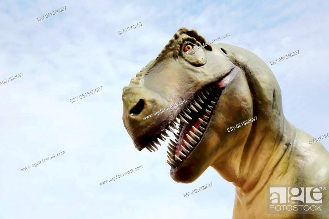 Stock Photo: Close up of tyrannosaurus rex dinosaur and sky background.