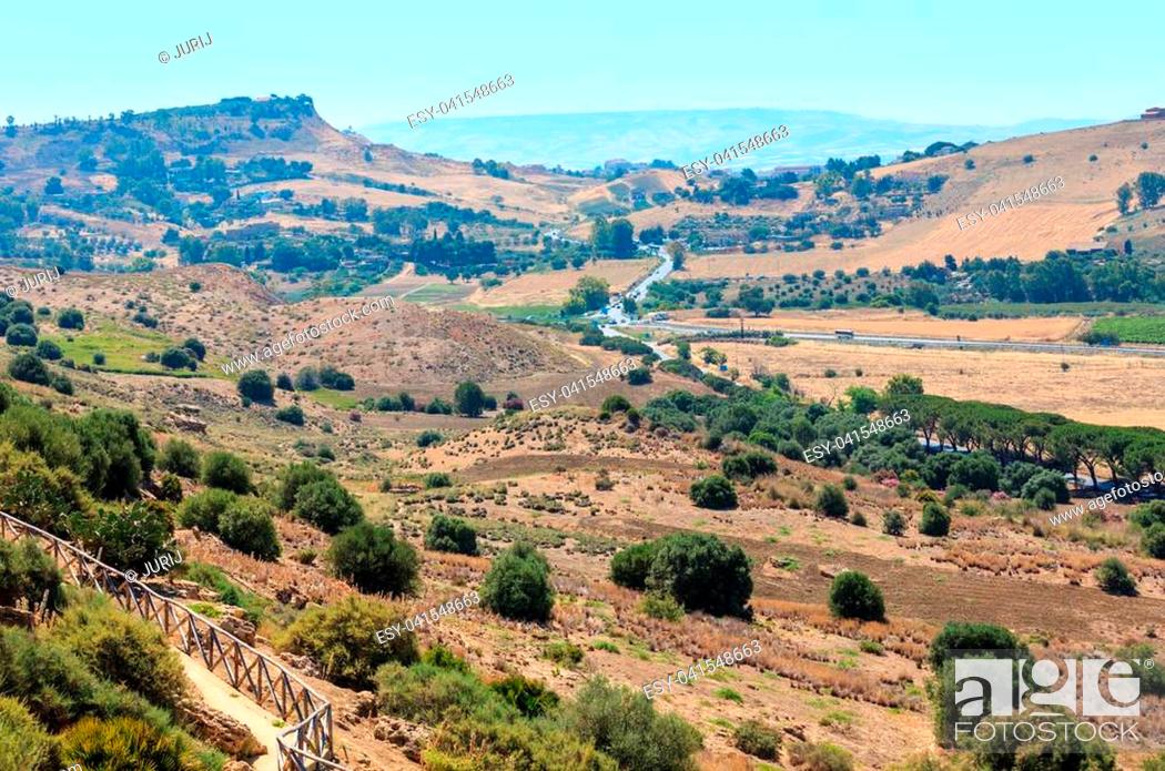 Stock Photo: View to road, gardens and mountain from famous ancient ruins in Valley of Temples, Agrigento, Sicily, Italy.
