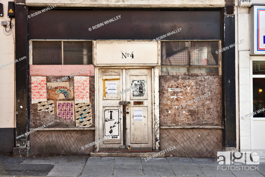 Stock Photo: England, Merseyside, Liverpool. Boarded and locked shop front.
