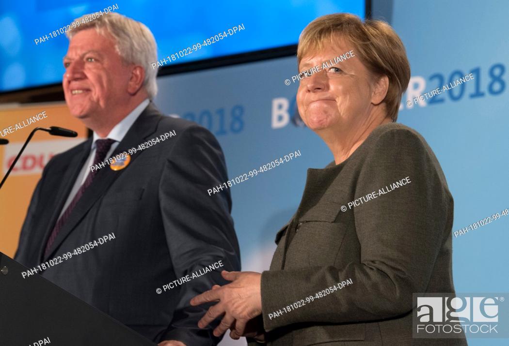 Stock Photo: 22 October 2018, Hessen, Ortenberg: Chancellor Angela Merkel (CDU) is standing in the marquee on the Cold Market next to Hessian Prime Minister Volker Bouffier.