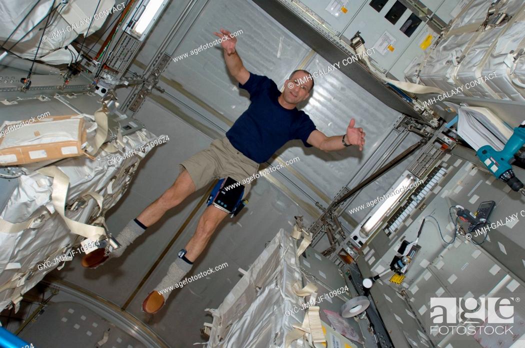 Stock Photo: Astronaut Donald Pettit, STS-126 mission specialist, floats in the Leonardo Multi-Purpose Logistics Module attached to the Earth-facing port of the.