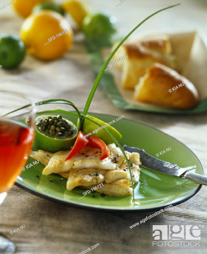 Stock Photo: Whiting fillets with capers and lime.