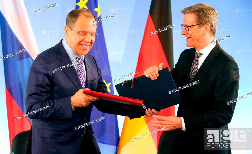 Stock Photo: German Foreign Minister Guido Westerwelle (FDP) and the Russian Foreign Minister Sergey Lavrov (L) sign an agreement between the governments of their countries.