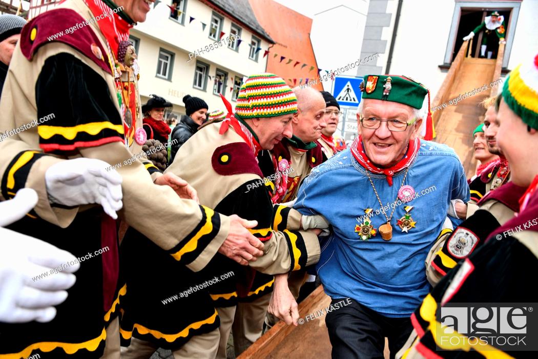 Stock Photo: Prime Minister of Baden-Wuerttemberg Winfried Kretschmann (The Greens) can be seen dressed up in a jester costume leaving a traditional culinary event in the.