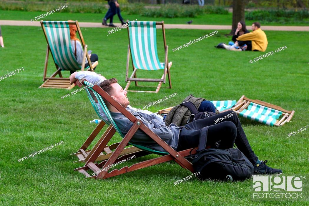 Stock Photo: Tourists and Londoners enjoy warm spring sunshine in St James Park in Westminster as higher temperatures are forecast across the UK in coming week.