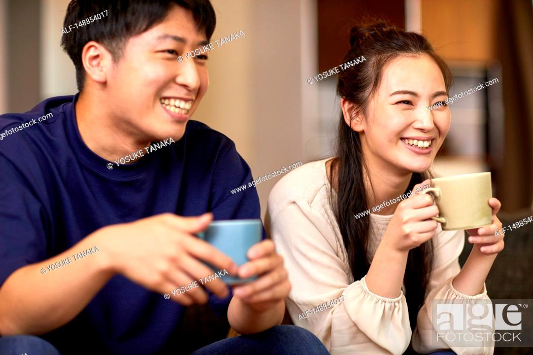 Stock Photo: Young Japanese couple at home.