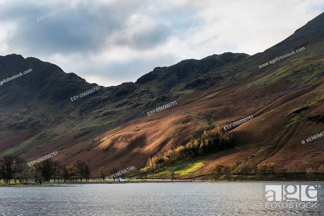 Stock Photo: Stunning epic Autumn Fall landscape Buttermere in Lake District with beautiful early morning sunlight playing across the hills and mountains.