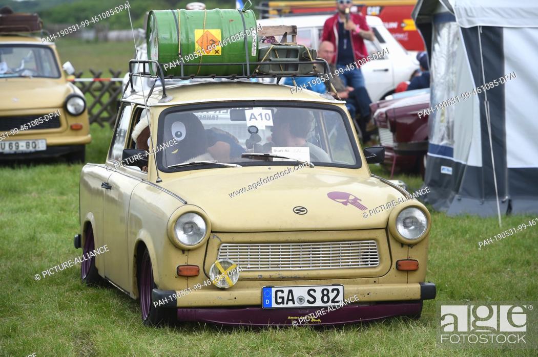Stock Photo: 31 May 2019, Mecklenburg-Western Pomerania, Anklam: A Trabant from GDR production drives on the grounds of the 25th International Trabant Meeting at the.