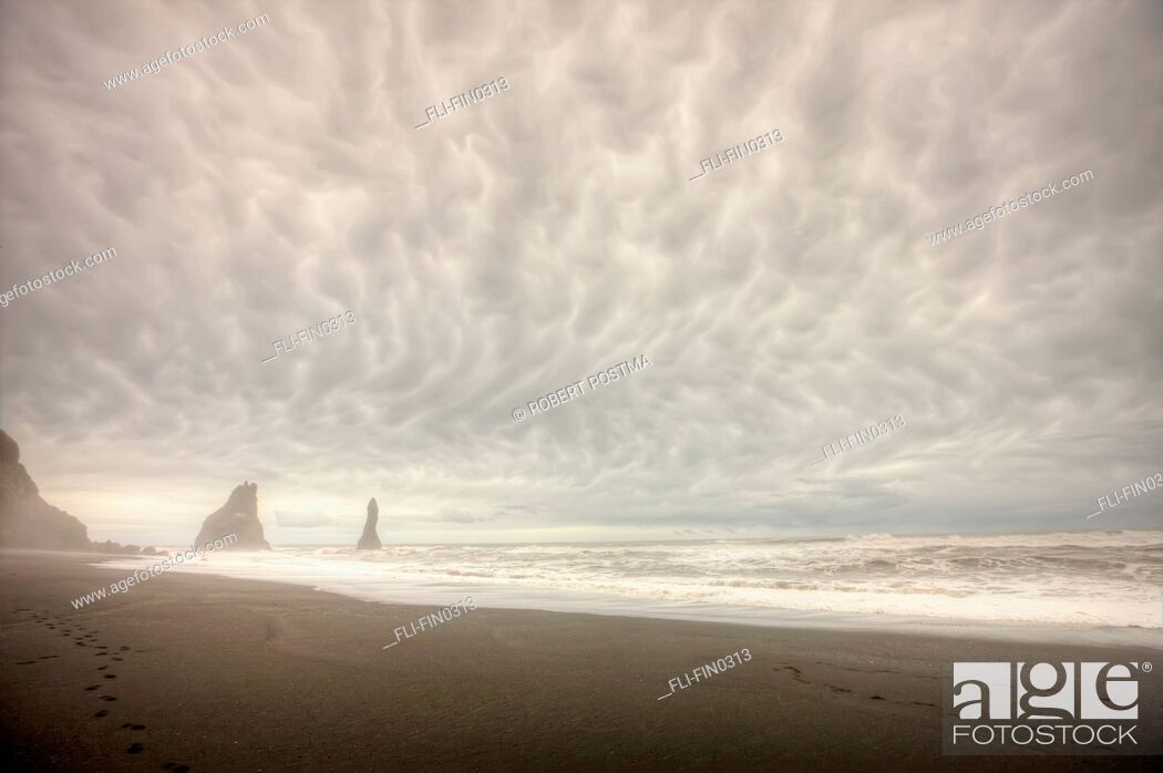 Stock Photo: Storm clouds over the ocean and sea stacks near Vik, southern Iceland.