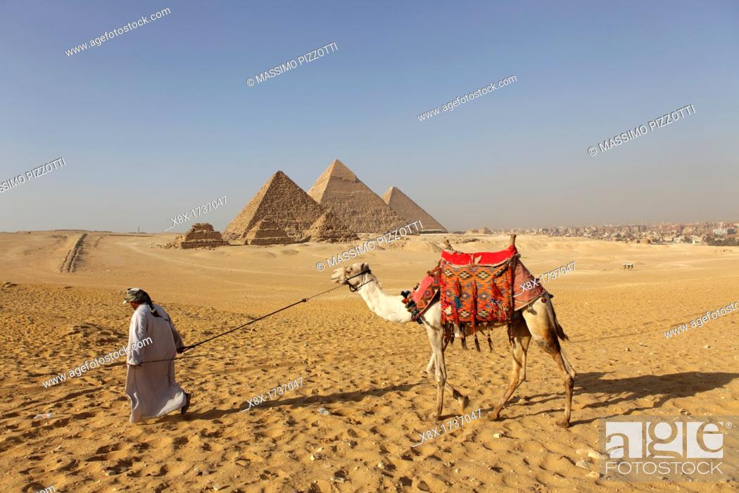 Stock Photo: Camel riding at Pyramid complex at Giza, Egypt.
