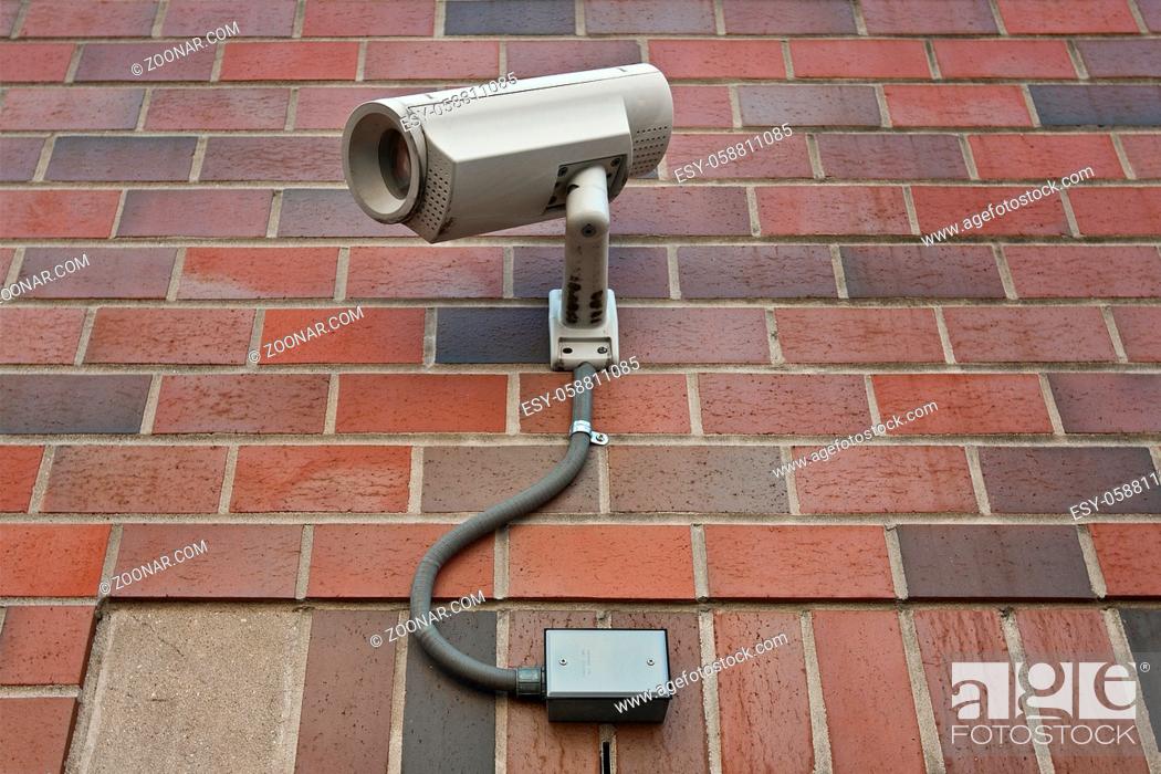 Stock Photo: cctv security video camera on outside wall of a building.