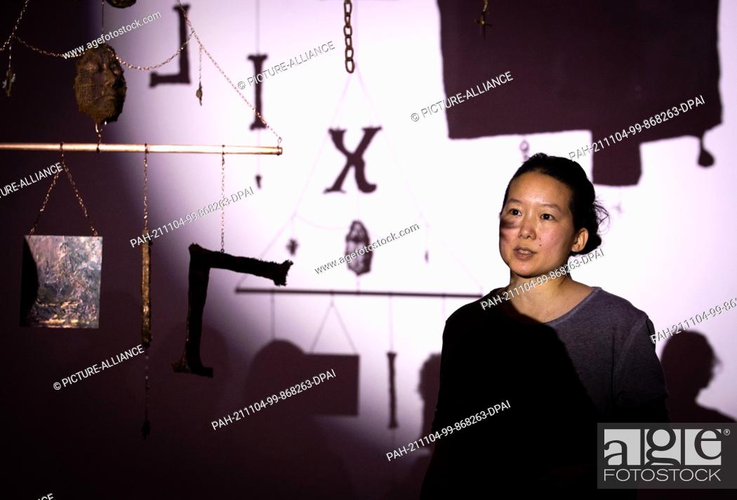Stock Photo: 04 November 2021, Lower Saxony, Osnabrück: US artist Candice Lin stands in front of her installation ""The Glittering Cloud"".