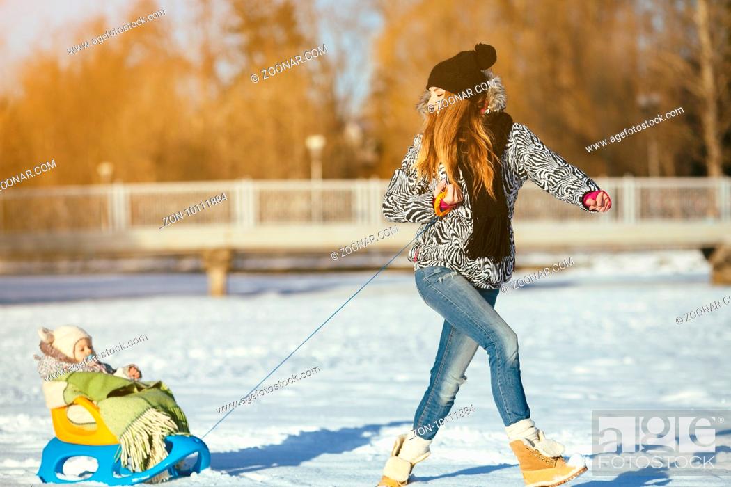 Stock Photo: happy family mother and baby girl daughter playing in winter outdoors in the snow.