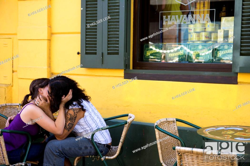 Stock Photo: Smooching couple outside Havanna Bar in La Boca district, Buenos Aires, Argentina, South America, America.