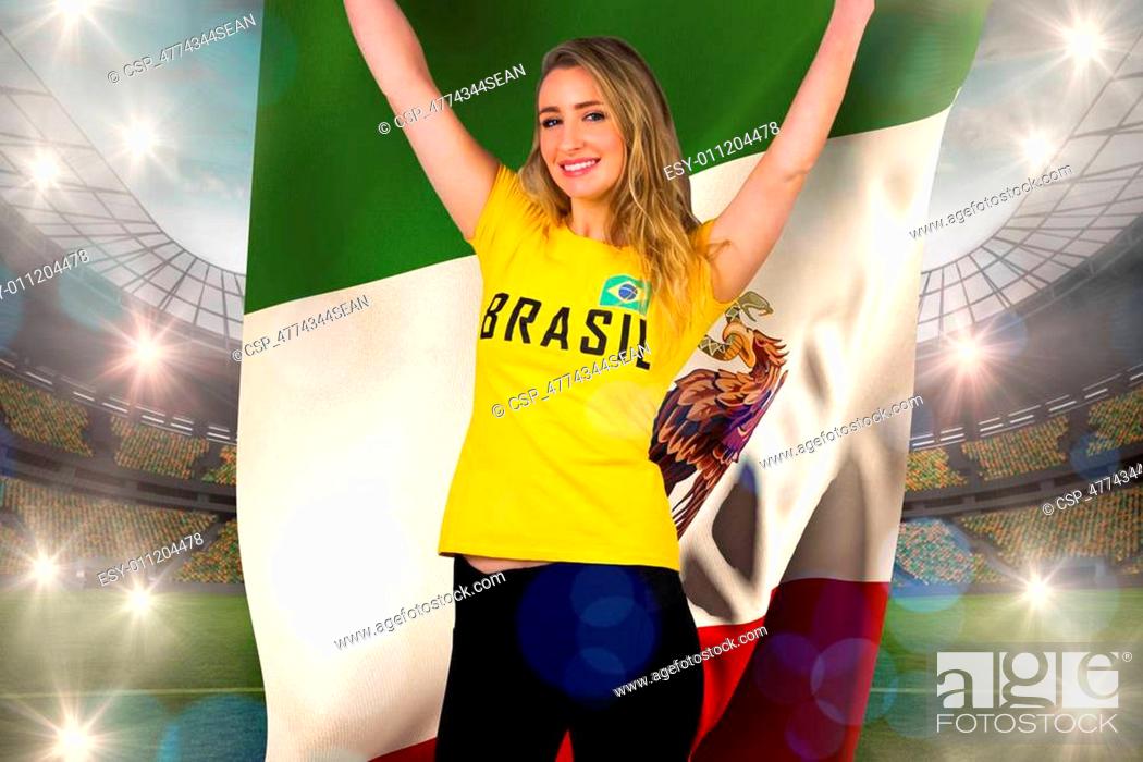 Stock Photo: Excited football fan in brasil tshirt holding mexico flag against large football stadium with lights.