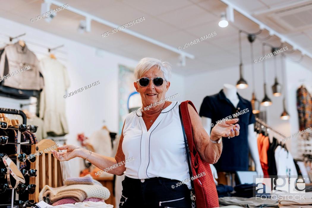 Stock Photo: Senior woman in clothes shop.