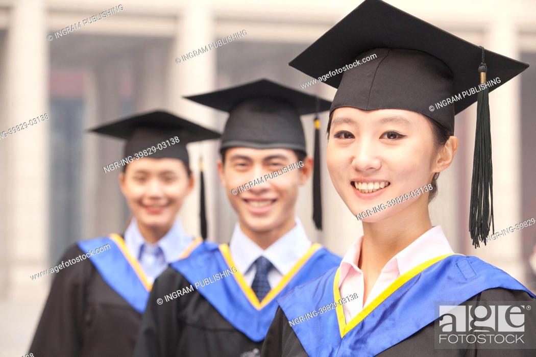 Stock Photo: Three University Graduates Smiling in a Row.