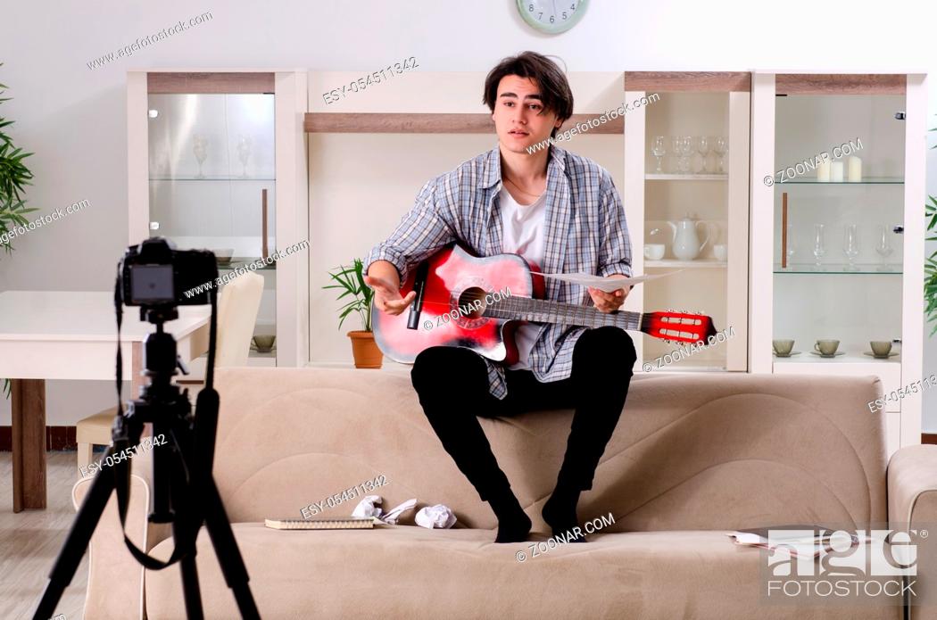 Stock Photo: The young guitar player recording video for his blog.