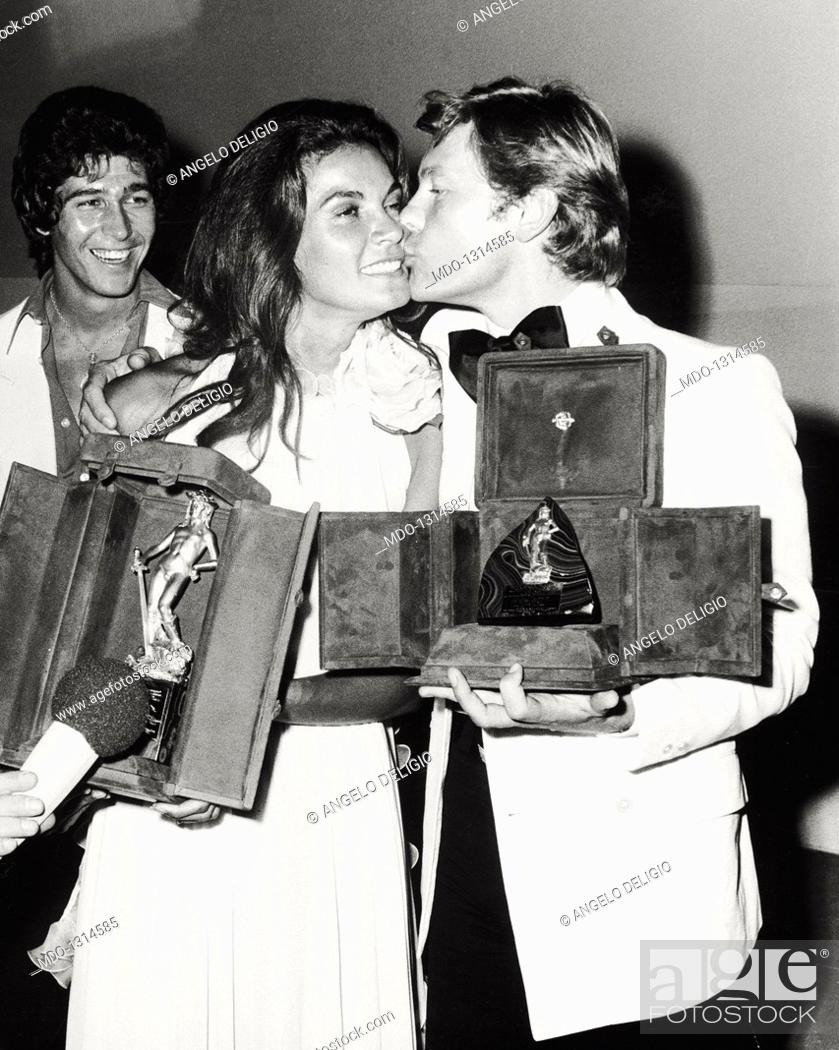Stock Photo: Helmut Berger, Florinda Bolkan and Ryan O'Neal at the David di Donatello Awards. Austrian actor Helmut Berger kissing the David di Donatello-winning Brazilian.