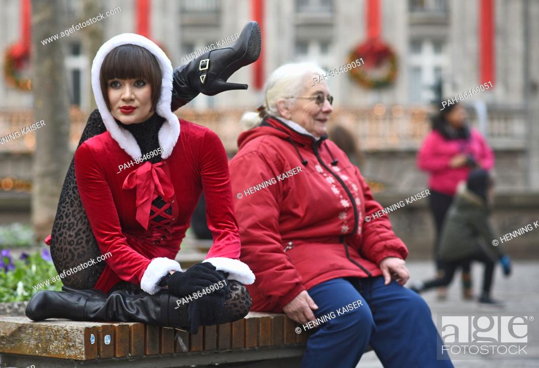 Stock Photo: Contortionist Alina Ruppel shows off her skills beside a member of the public on a bench in Cologne, Germany, 12 December 2016.