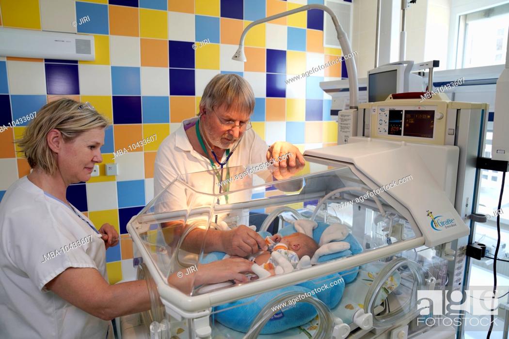 Stock Photo: Doctor and nurse during an examination, intensive care unit for newborns, Karlovy Vary, Czech Republic.