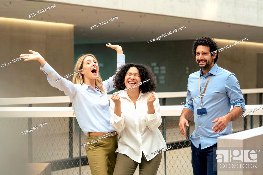 Stock Photo: Cheerful business colleagues enjoying in corridor.