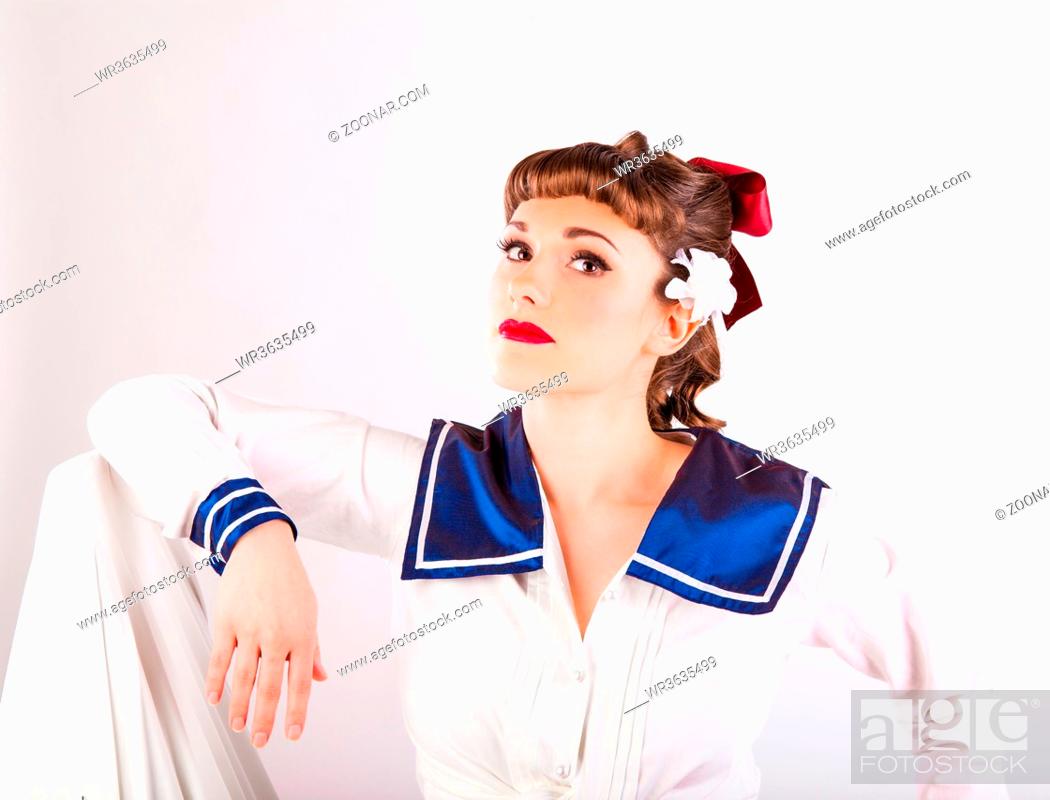 Stock Photo: young girl in fifties pin-up style wearing a sailors uniform.