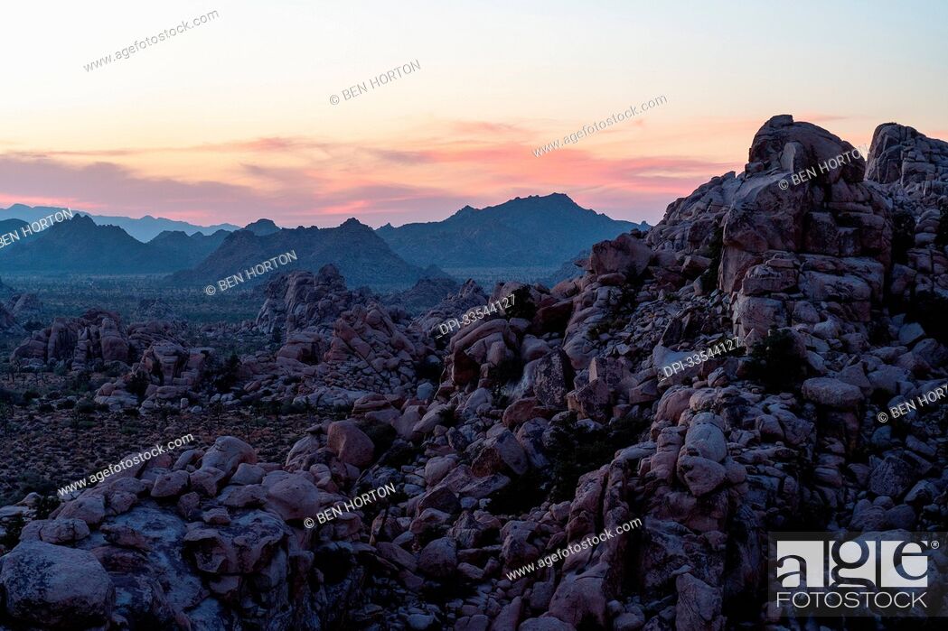 Stock Photo: Sunset over the famous granite domes and rock formations of Joshua Tree National Park; Joshua Tree National Park, California, United States of America.