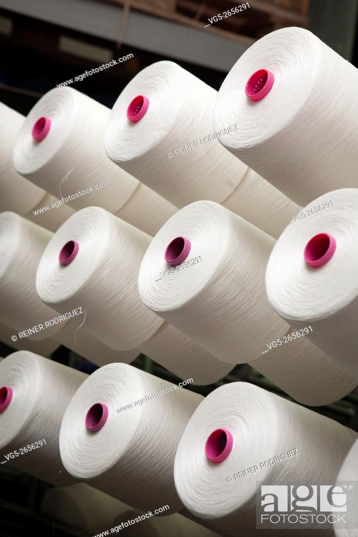 Stock Photo: production of fine woolen fabrics for suits - in a factory in Sabadell, Spain. rolls of woolen threads.