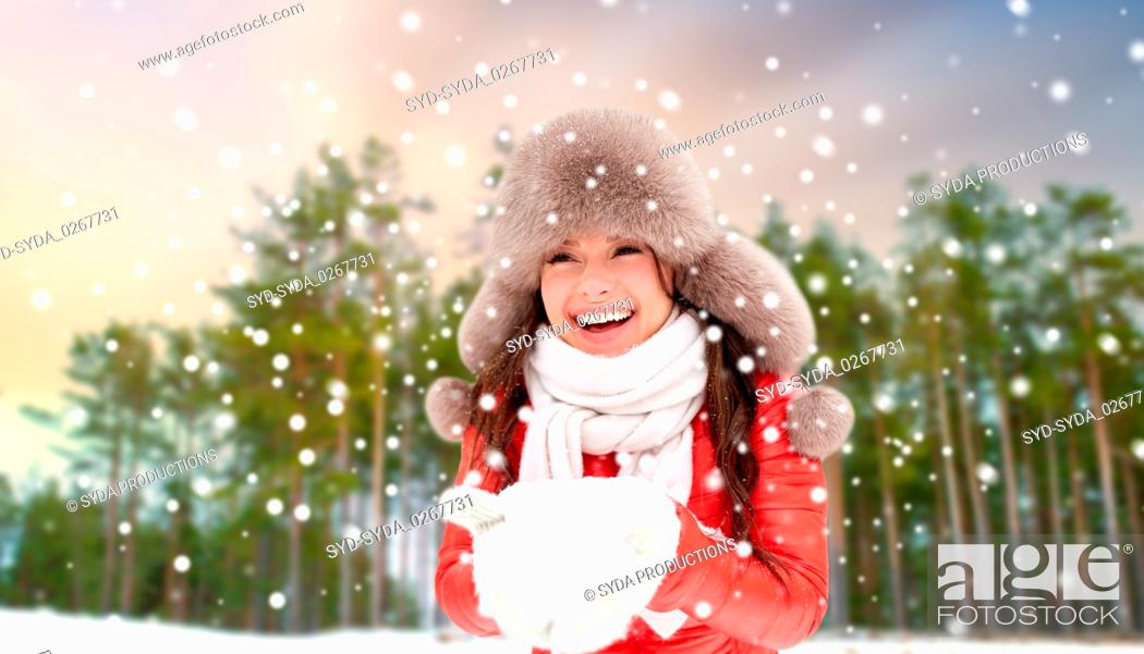 Stock Photo: woman in fur hat with snow over winter forest.