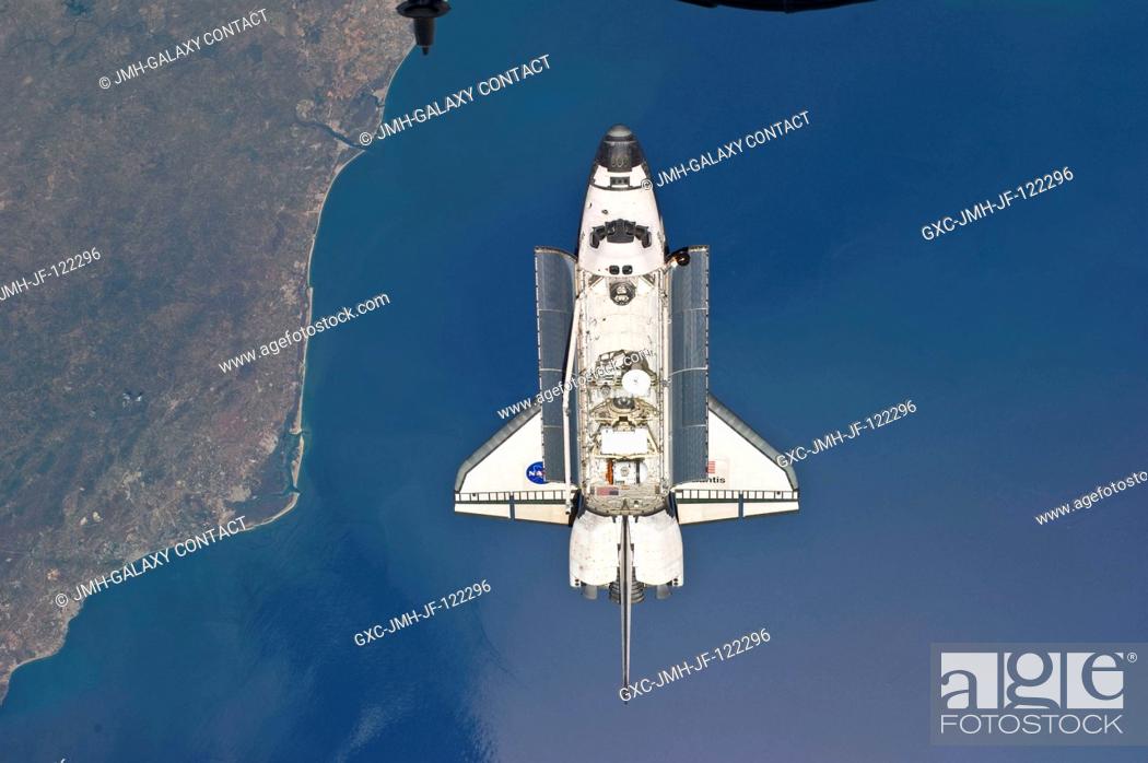 Stock Photo: Backdropped by a colorful Earth, space shuttle Atlantis is featured in this image photographed by an Expedition 23 crew member as the shuttle approaches the.