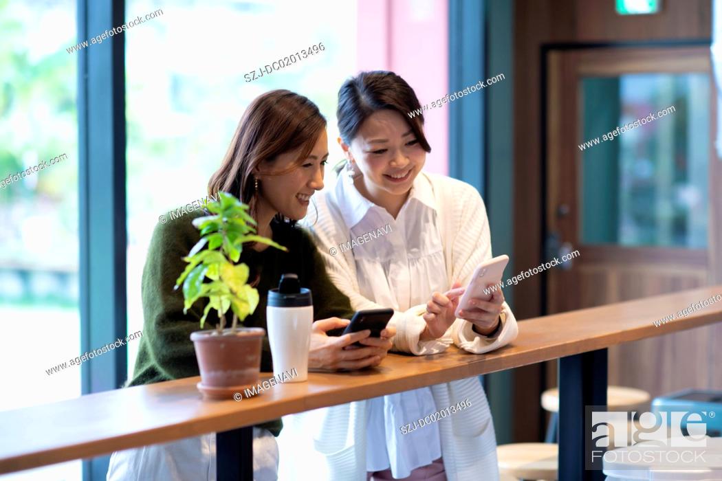 Stock Photo: Two women having meeting in café.