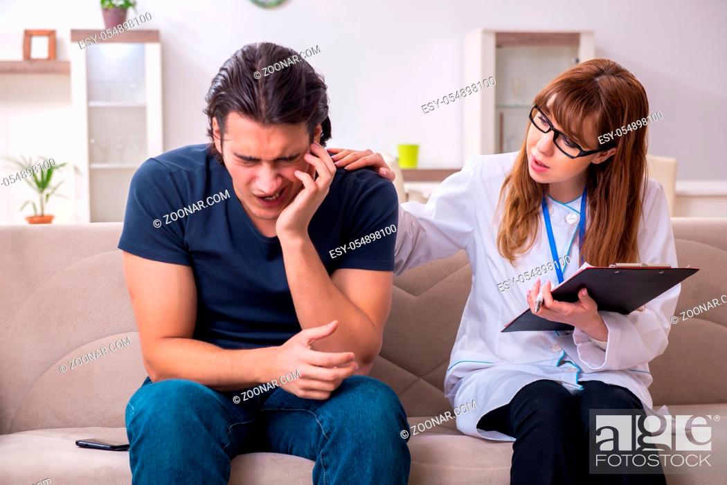 Stock Photo: The young male patient discussing with female psychologist personal.