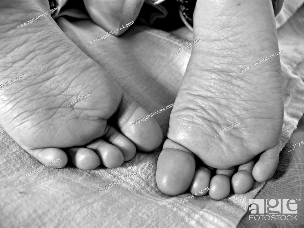 Stock Photo: Close-up of a child's feet sleeping in a bed.